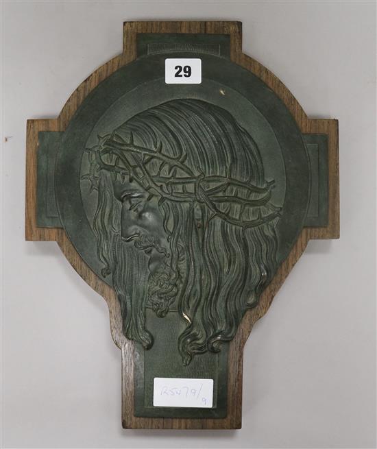 A bronze plaque of Christ on modern base H.36cm